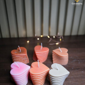 Heart-shaped layered candle in soft pink tones